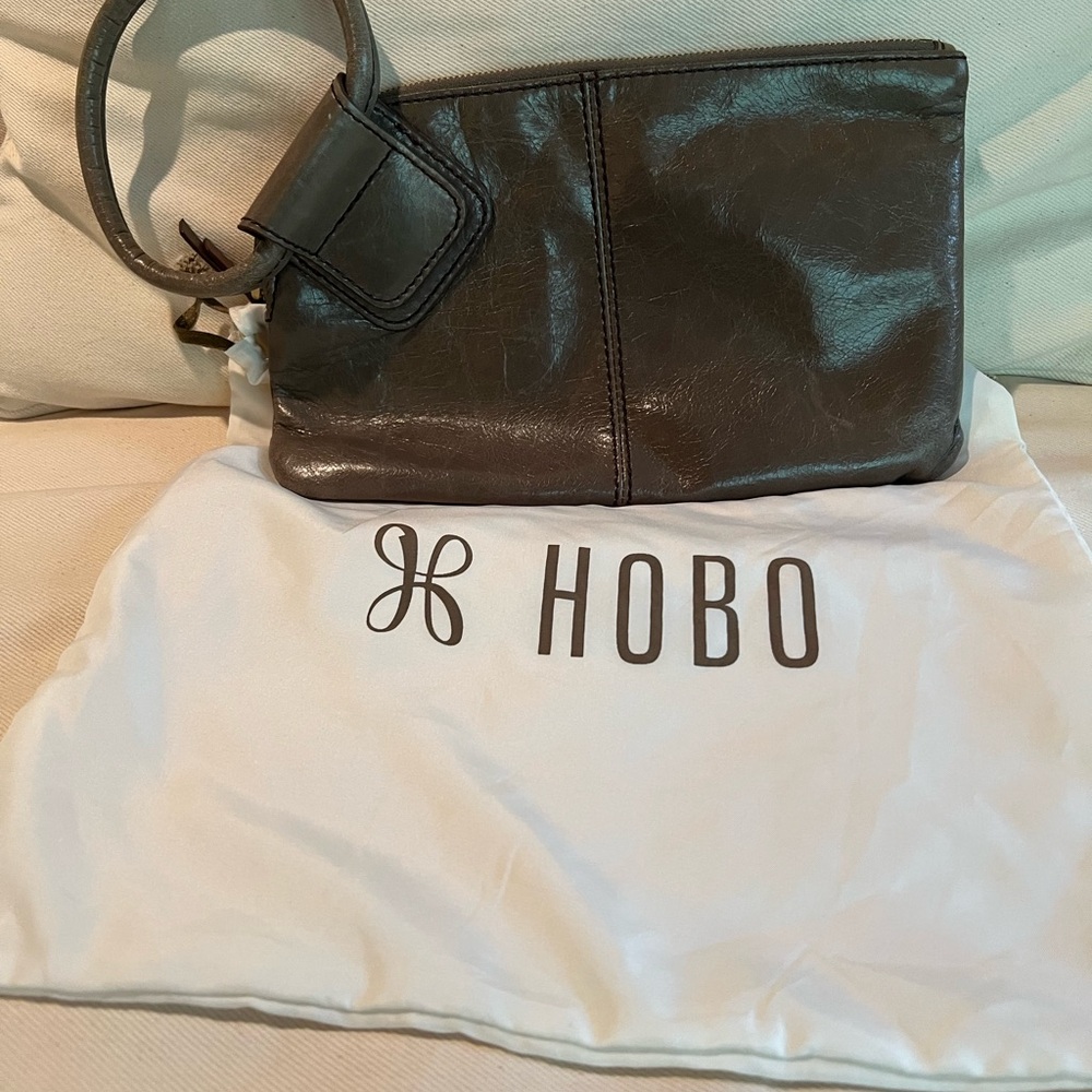 HOBO Clutch with Floral Interior Taupe in color.
